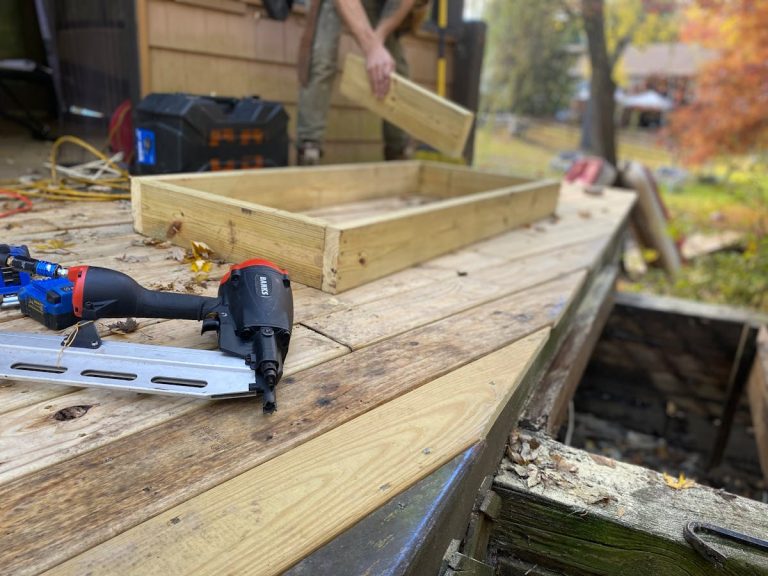 Carpentry work with nail gun on deck construction