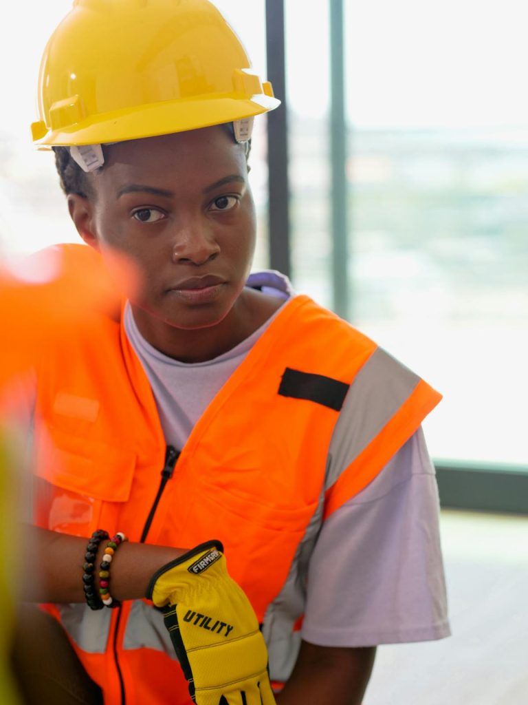 Female construction worker wearing safety gear and helmet