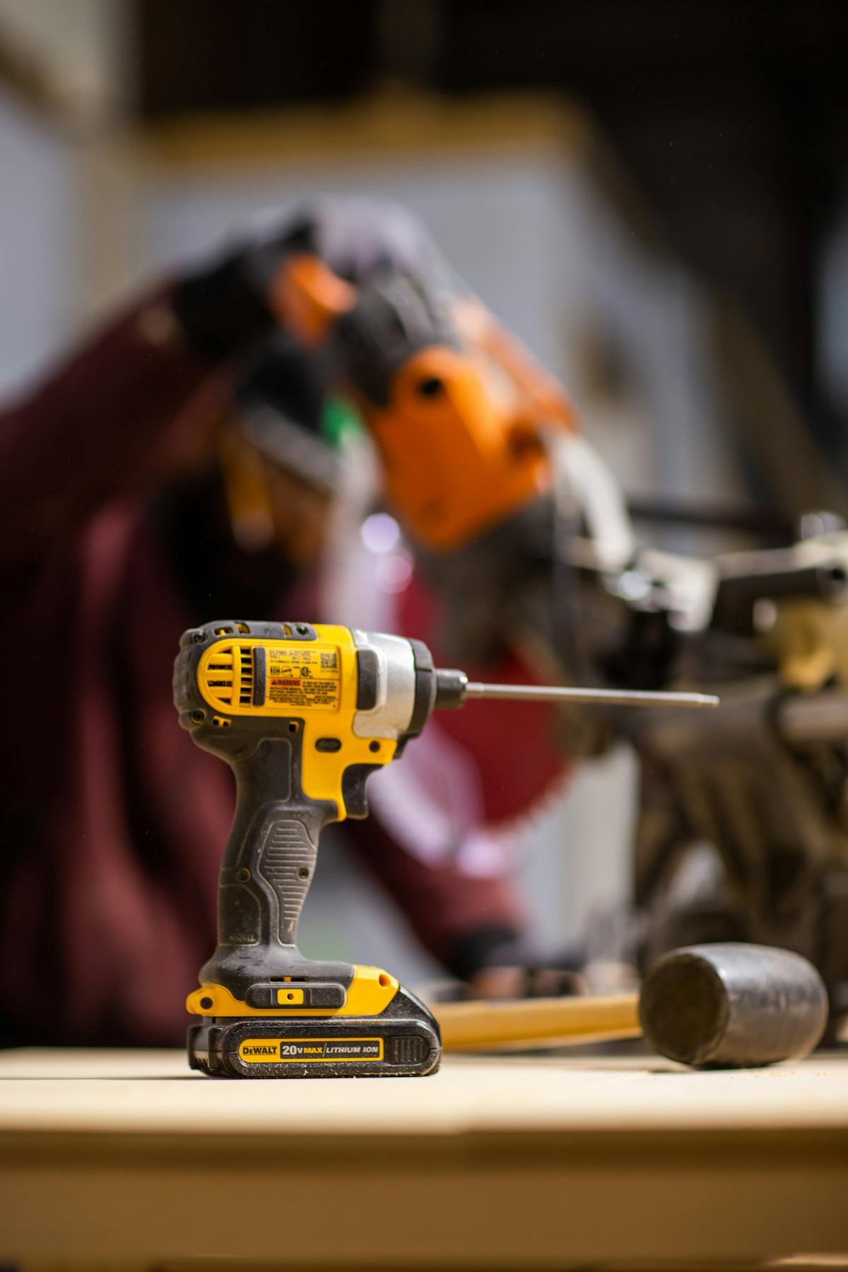 Cordless drill with lithium battery in workshop setting