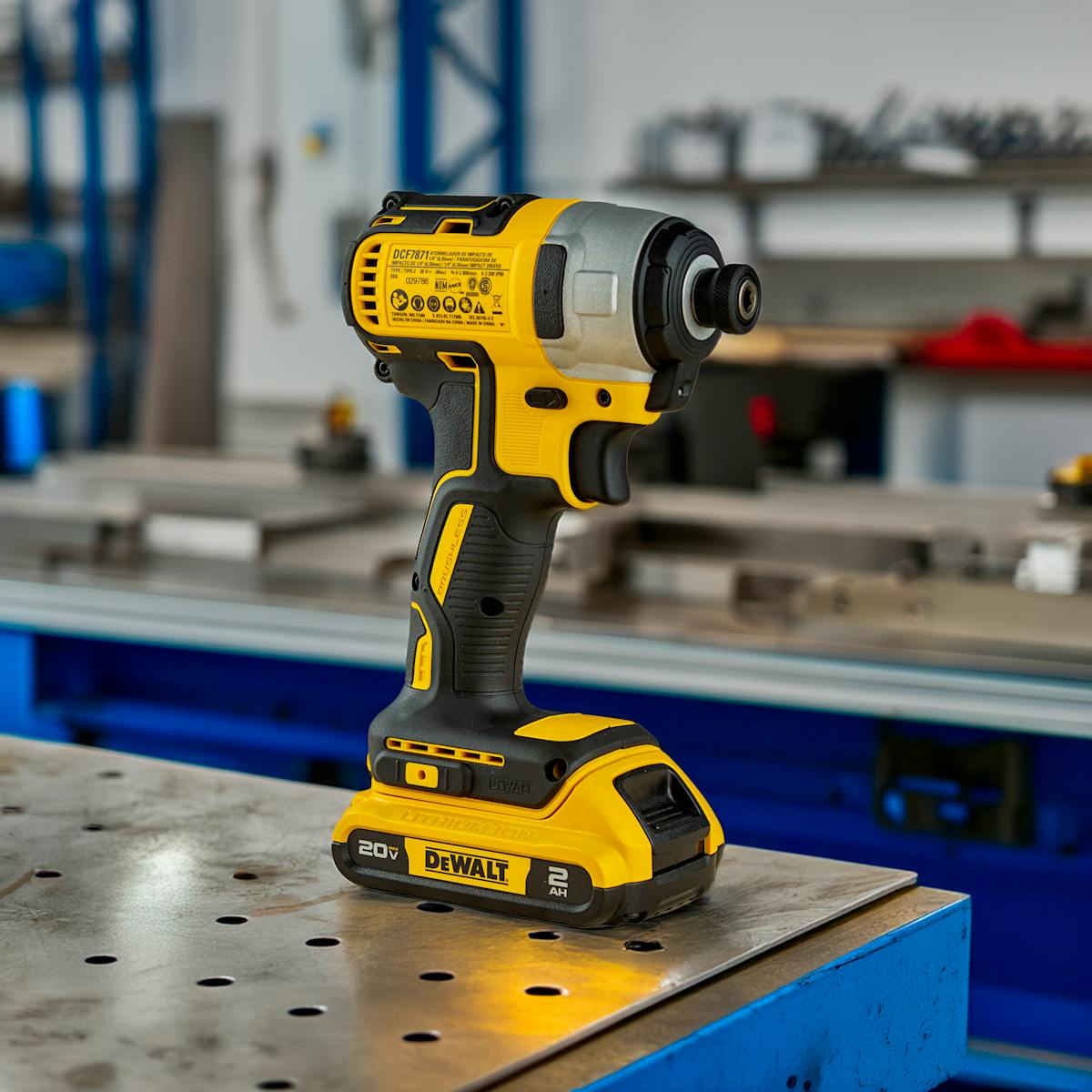 Yellow cordless drill on metal table in workshop