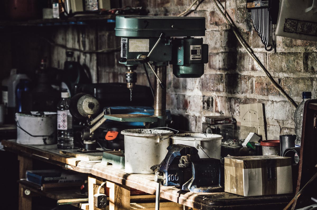 Cluttered workshop with drill press and DIY workbench tools