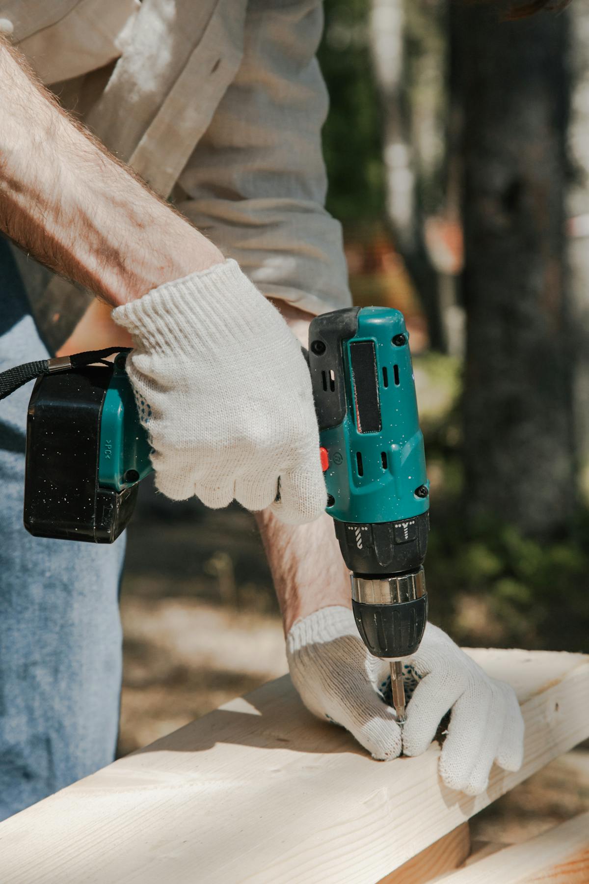 Construction worker using cordless drill showing torque power