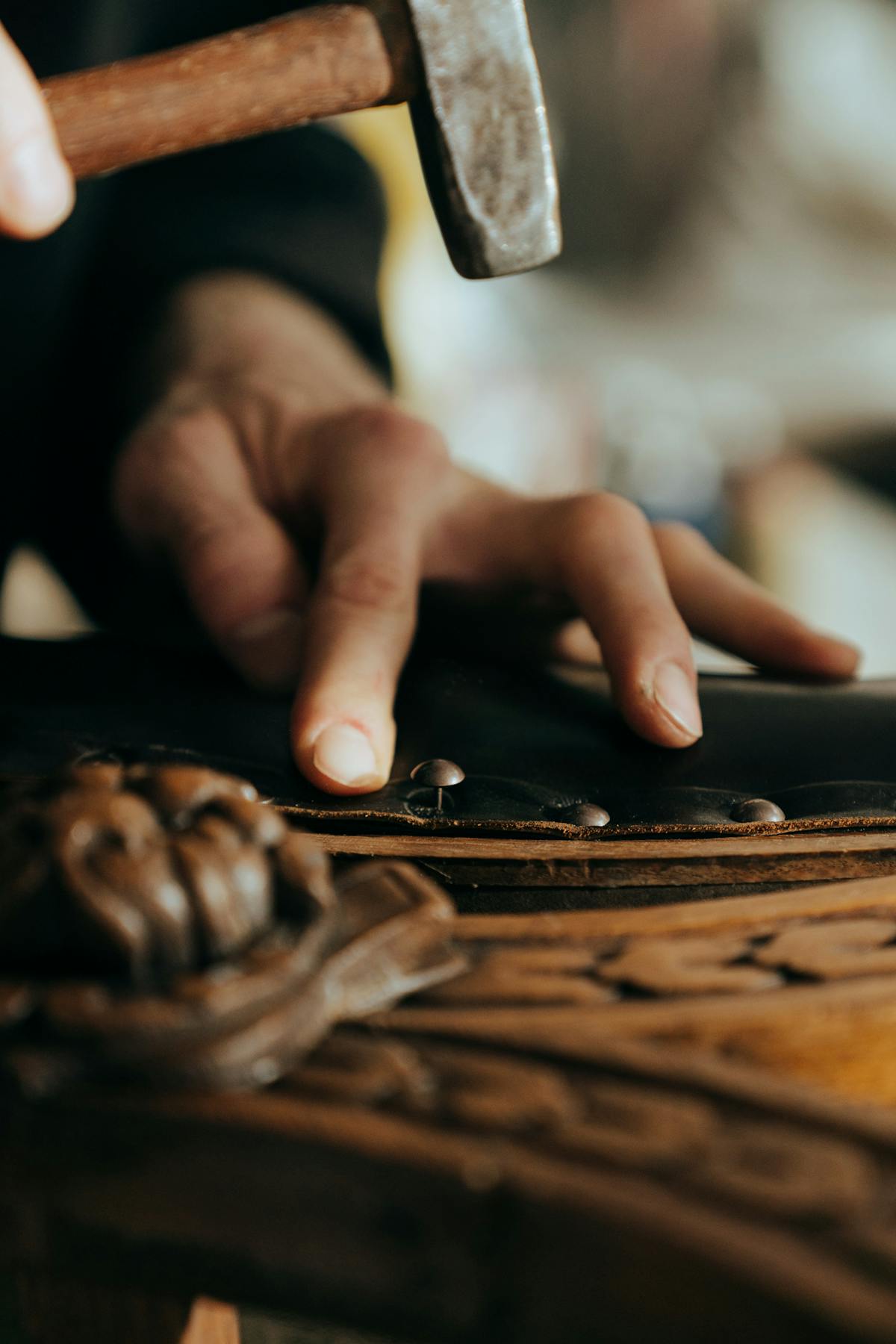 Craftsman sanding vintage wooden furniture for refinishing