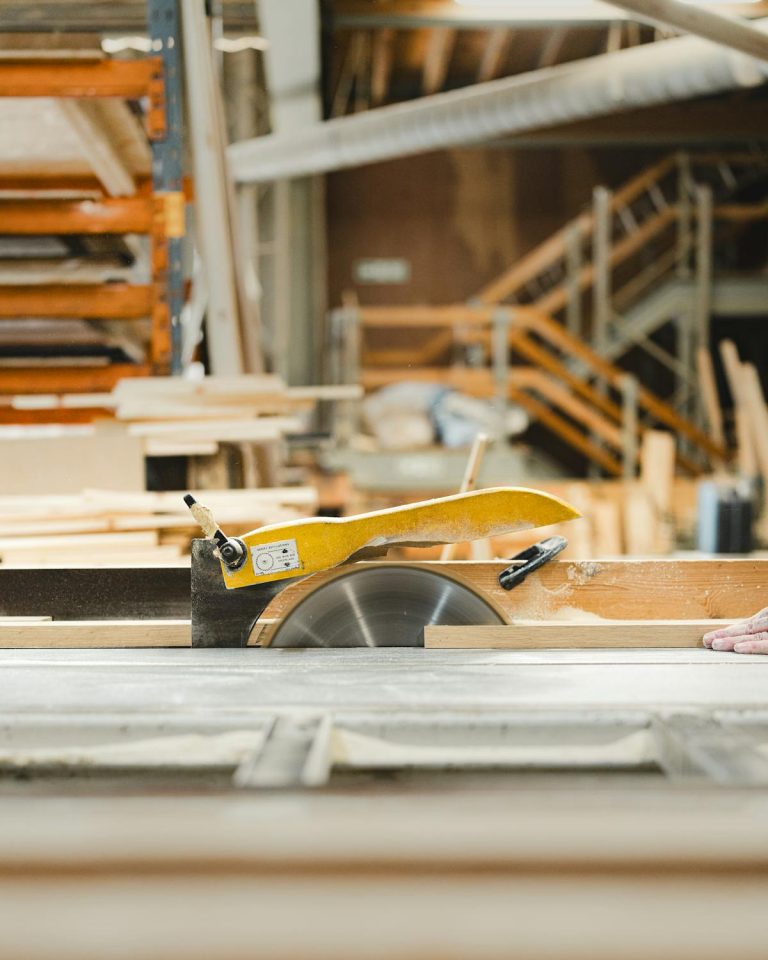 Circular saw and wood planks in busy workshop