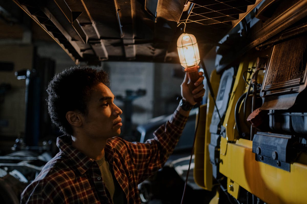 Mechanic working under bright workshop lighting